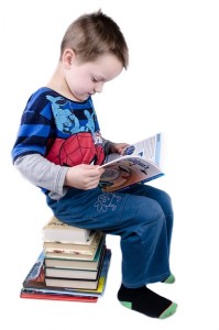 Here's an alt tag for the image: `Young boy engrossed in reading a book`