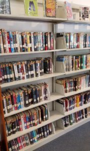 Here's an alt tag for the image: Bookshelf filled with various books.